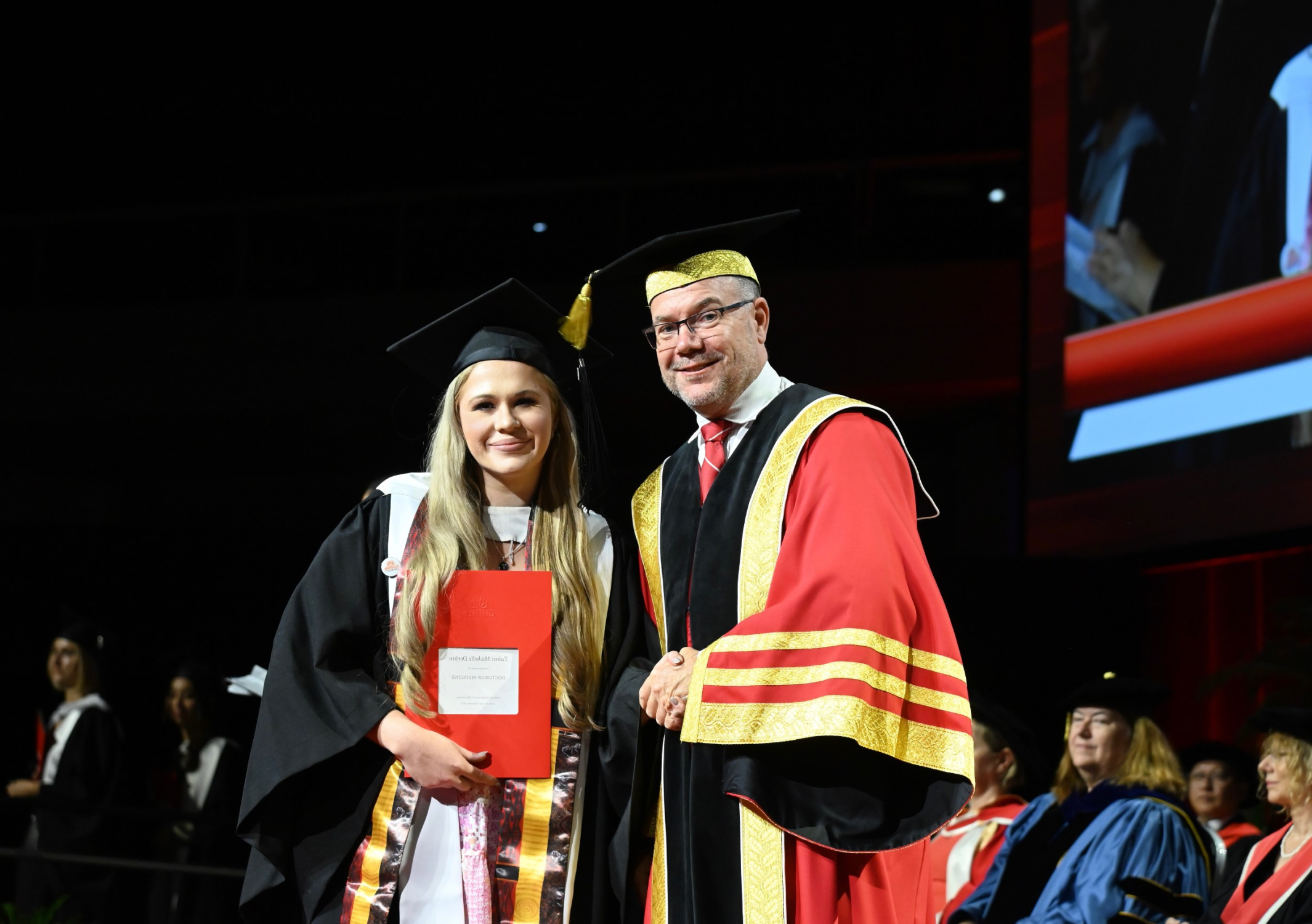 Young woman receiving degree at university 