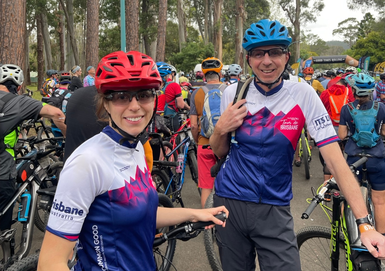 Man and women in bicycle gear standing with their bikes 