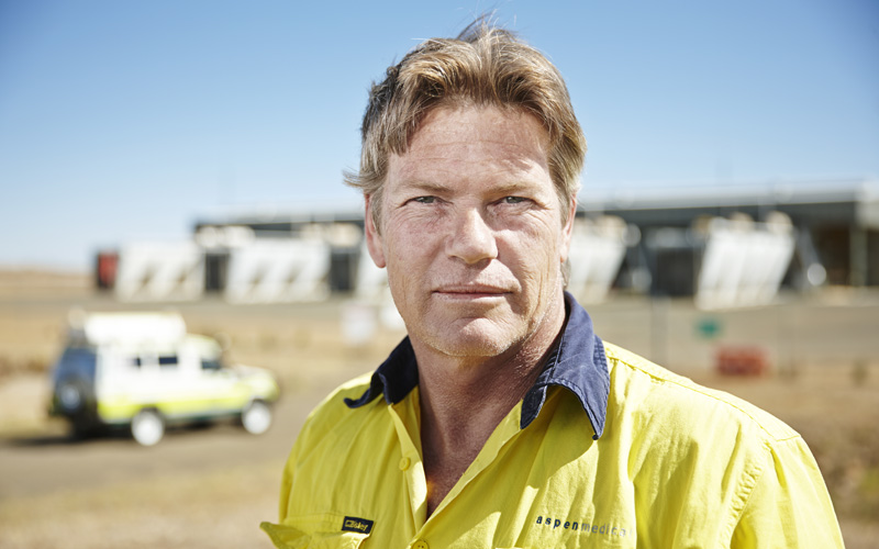This photo shows a male worker outside at a remote worksite.