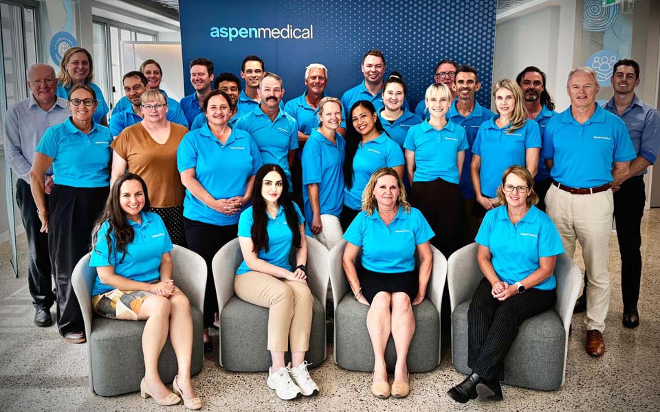 Group photo of the JP2060 team wearing blue Aspen Medical polo tops.