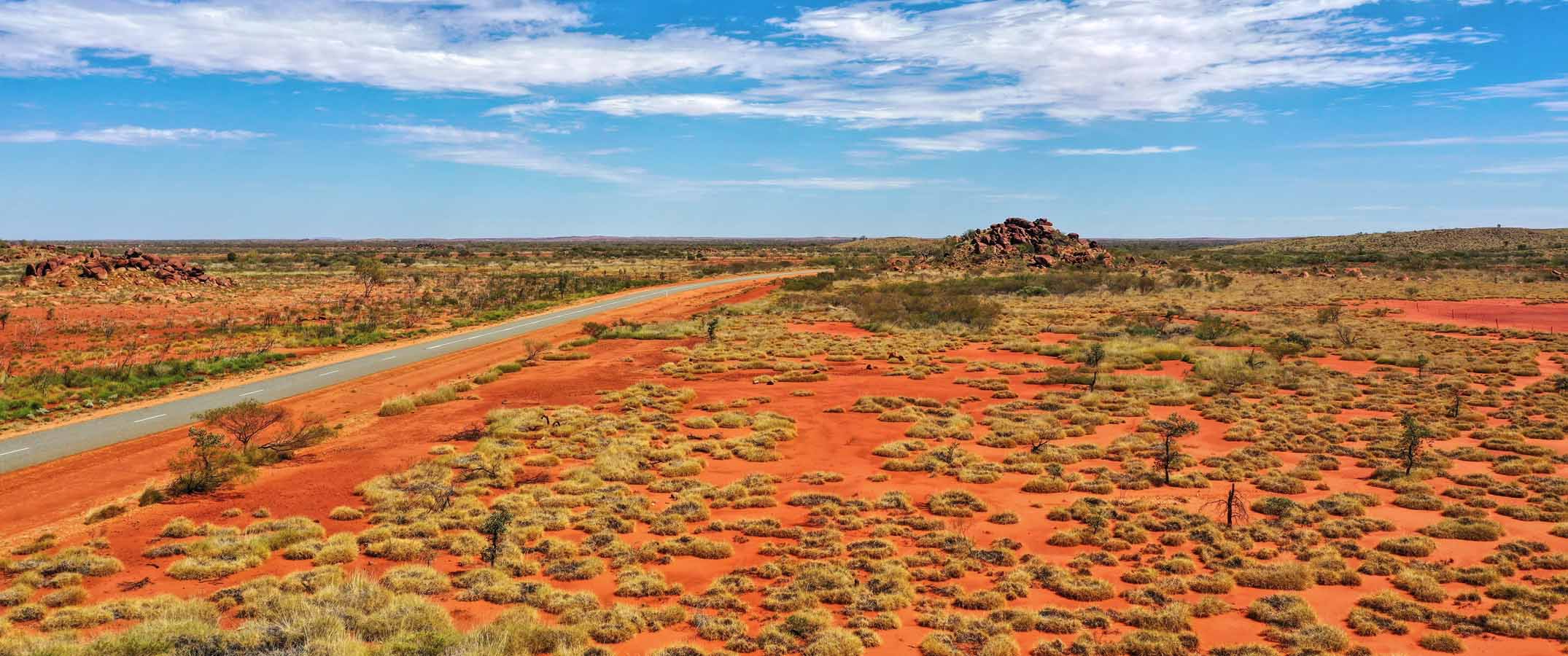 Landscape phone of the red earth of the Australian outback contrasting with the blue sky.