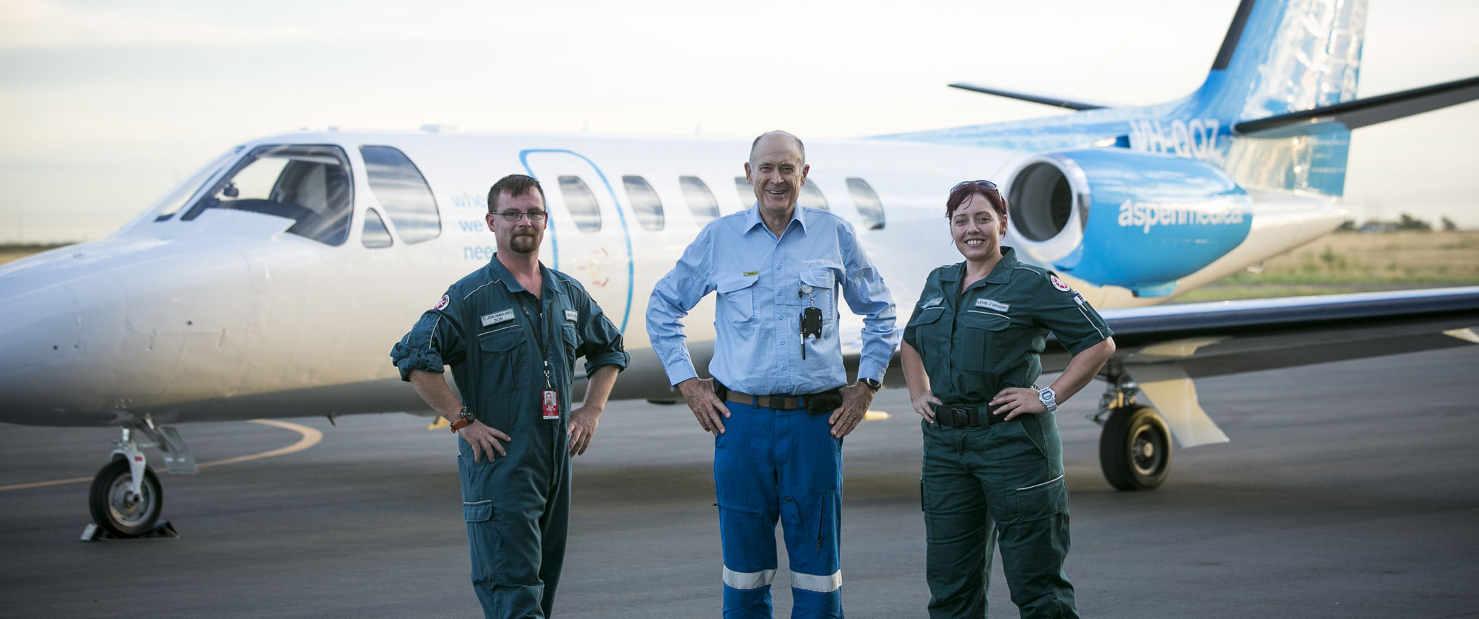 Photo of three Aspen Medical clinicians standing infront of our aircraft.