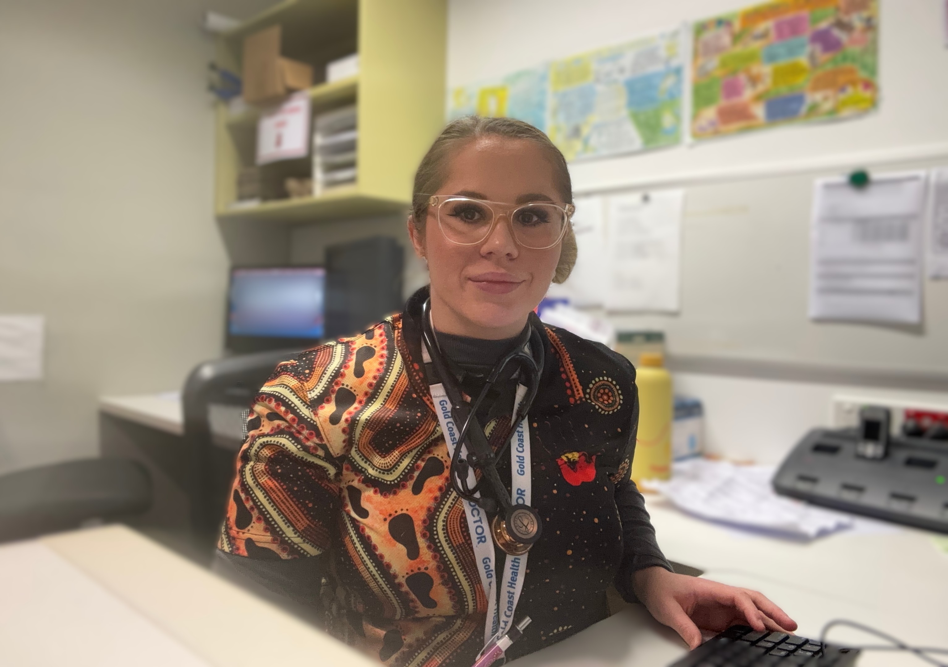 Female doctor at a desk in a clinical setting 