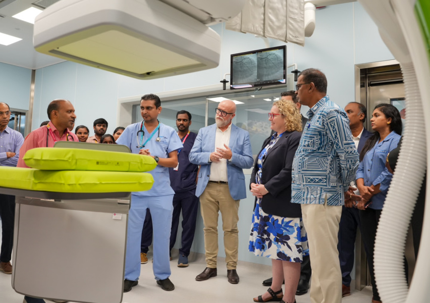 People gathered around medical equipment for a show and tell event