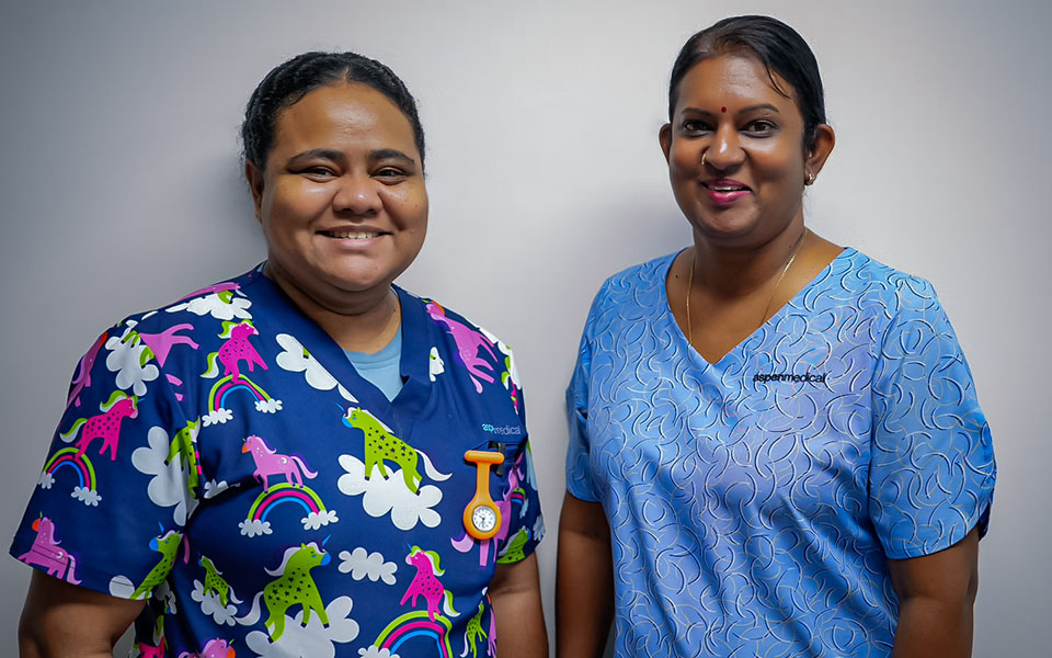 Foundation scholarship recipients Agnes and Leena, standing together and smiling.