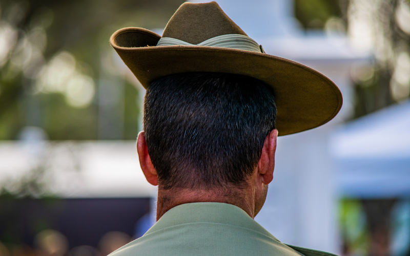 Photo shows the back of the head of an Australian soldier wearing his hat.