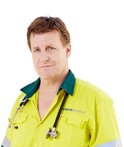 Photo shows a male Aspen Medical clinician in high vis at an oil and gas client site.
