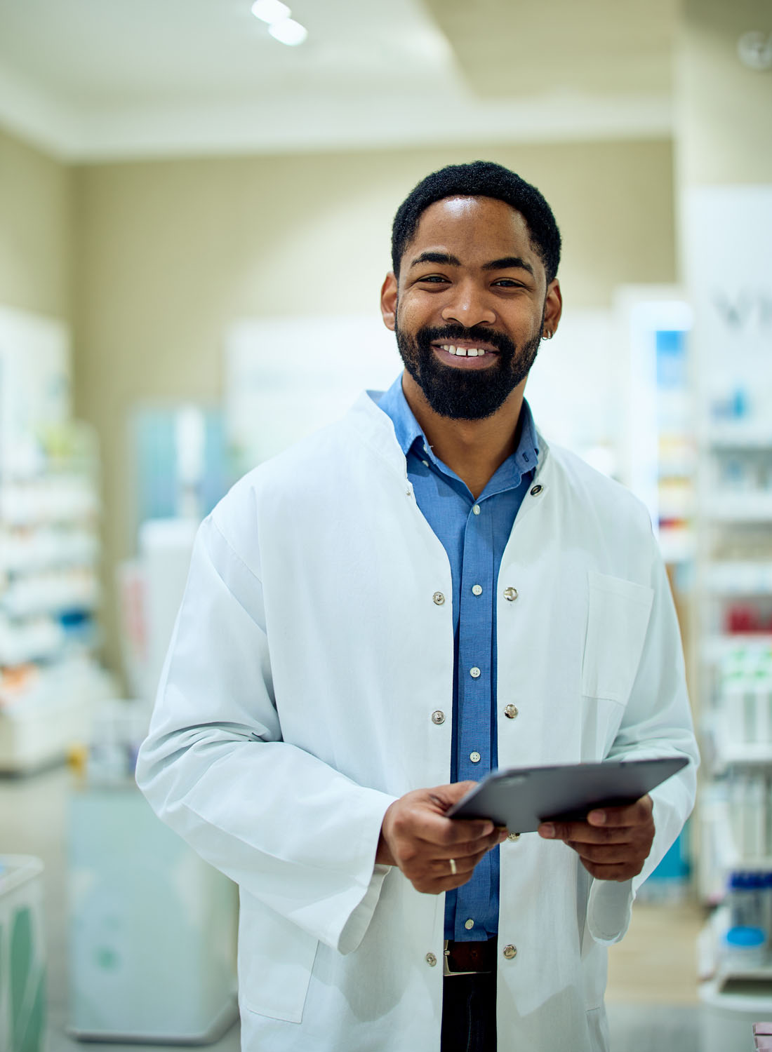 Photo shows a male clinician in a white lab coat holding a clip board.