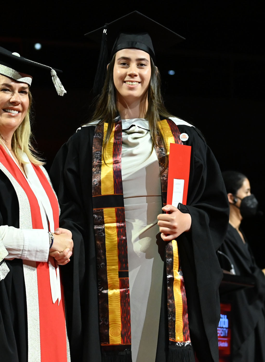 Photo shows a scholarship recipient graduating from university.