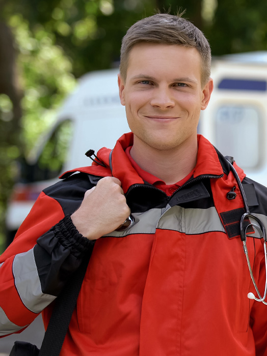 Photo shows a close up of a male paramedic in full uniform.