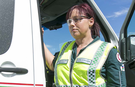 Image shows an Aspen Medical paramedic exiting an ambulance.