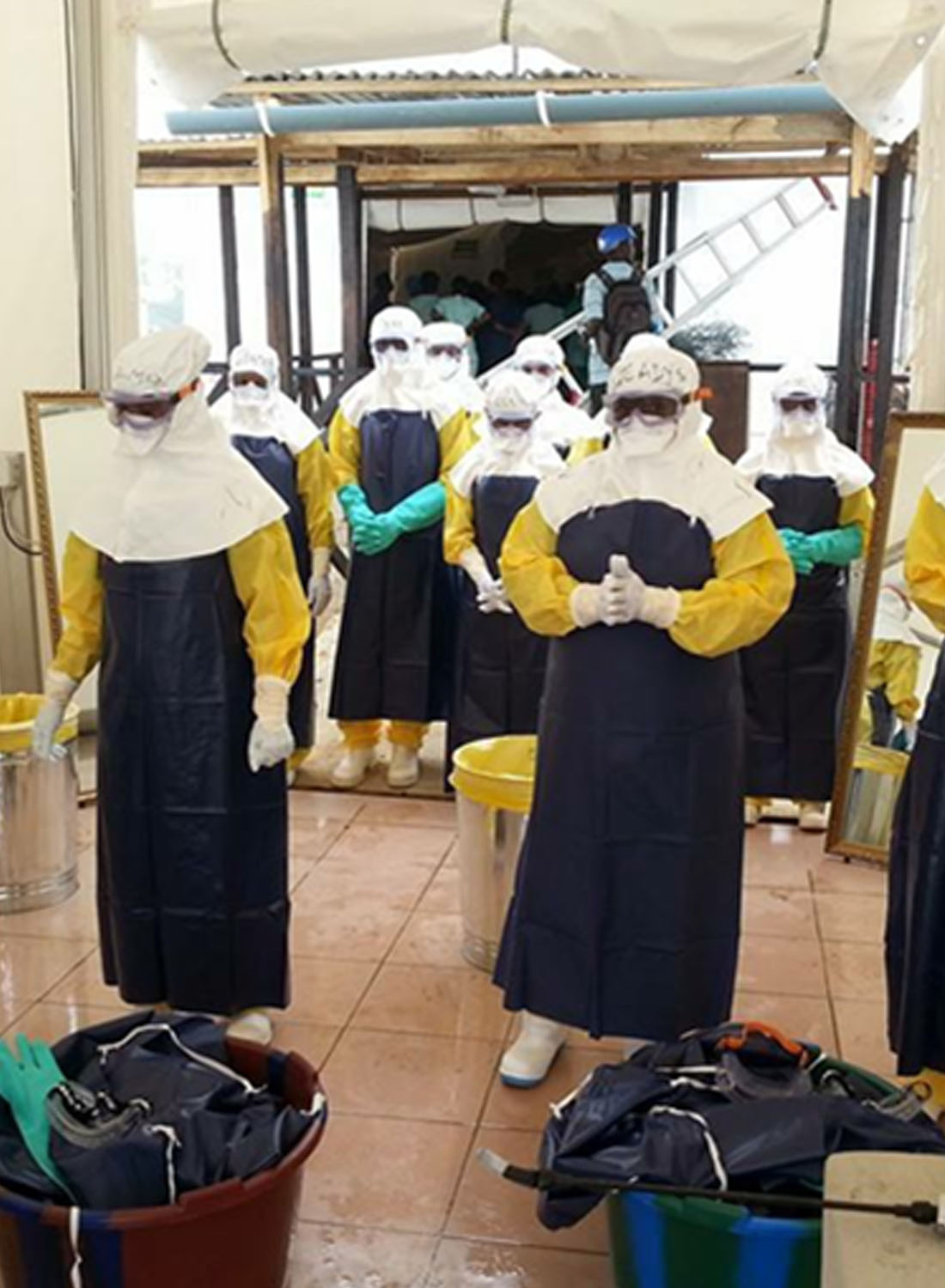 Photo shows Aspen Medical clinicians in full PPE during Ebola crisis.