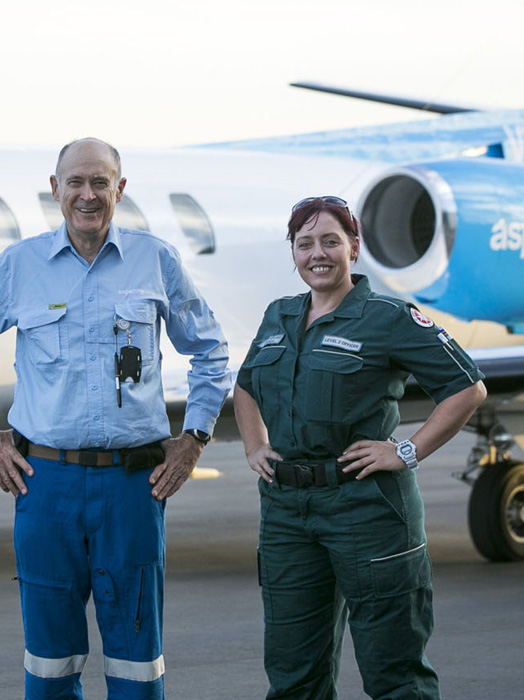 Photo of two Aspen Medical clinicians standing infront of our aircraft.
