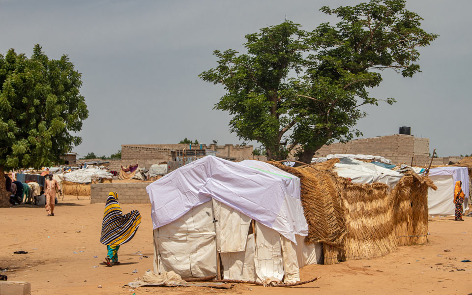 Photo of refugee camp in Africa, full of people who took refuge due to insecurity and armed conflict. People living in very poor conditions, lack of food, clean water and proper shelter to stay in.