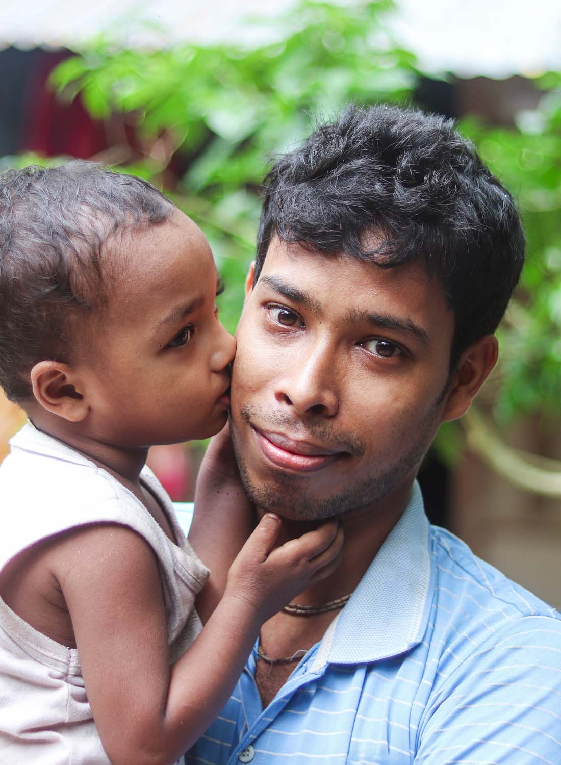 Photo of a young asian father holding his child.