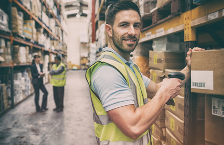 Image shows a man working in a warehouse wearing high vis.