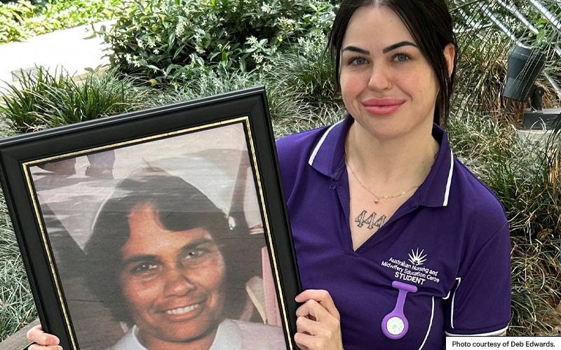 Photo shows a scholarship recipient holding a framed photo of the person who inspired her to study nursing.