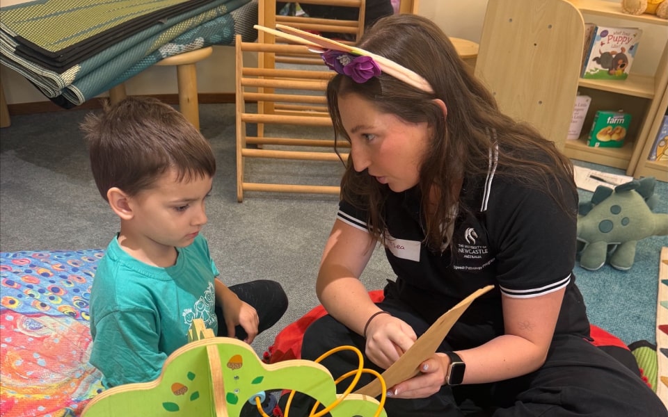Young woman with child learning 