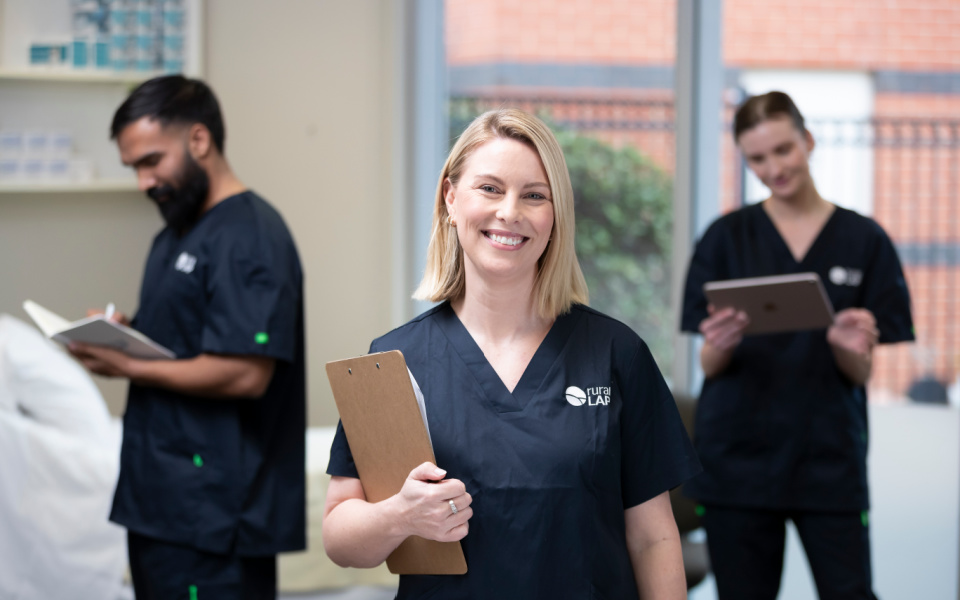Corporate style photo of three clincians in a ward