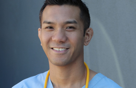 Image shows a young, male healthcare worker.