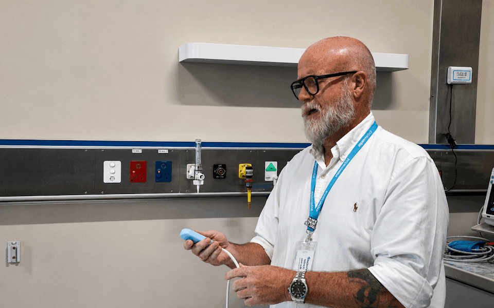 Man in hospital testing a Nurse Call System