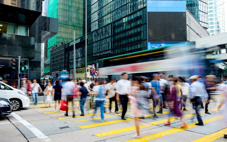 People crossing the road at a busy intersection