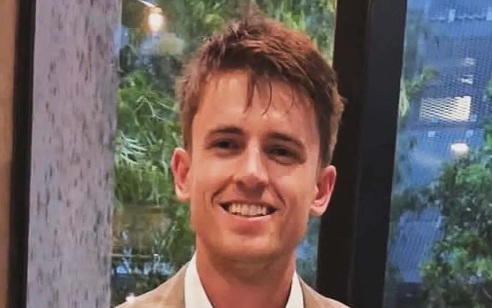 Photo of Jack Davies, smiling at the camera and wearing a blazer and white shirt.