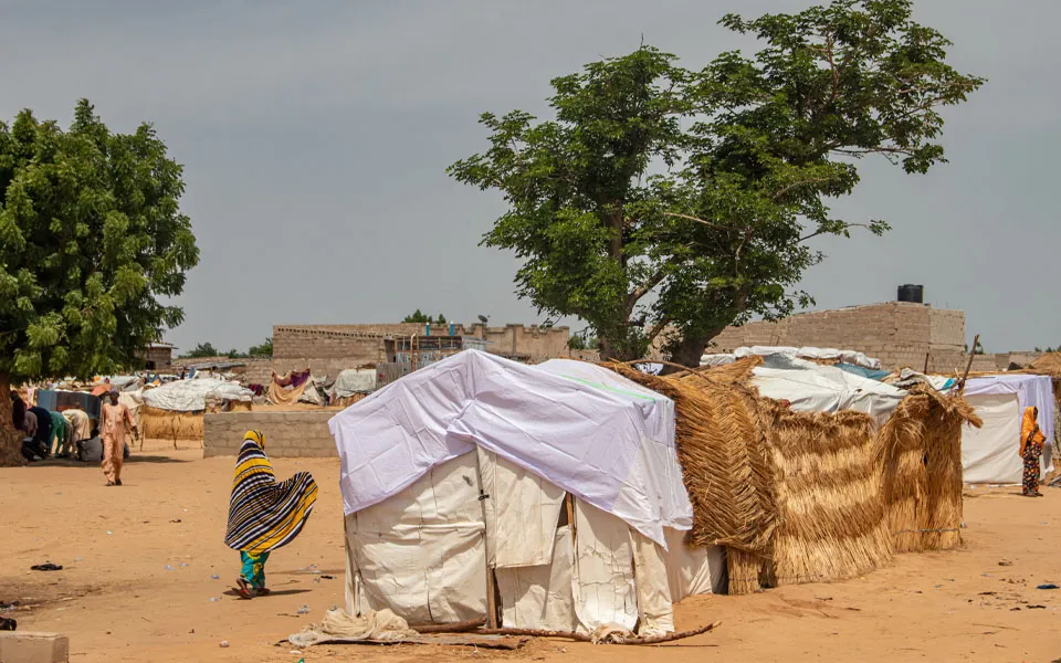 Photo of refugee camp in Africa, full of people who took refuge due to insecurity and armed conflict. People living in very poor conditions, lack of food, clean water and proper shelter to stay in.