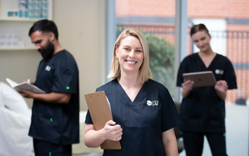 Corporate style photo of three clincians in a ward