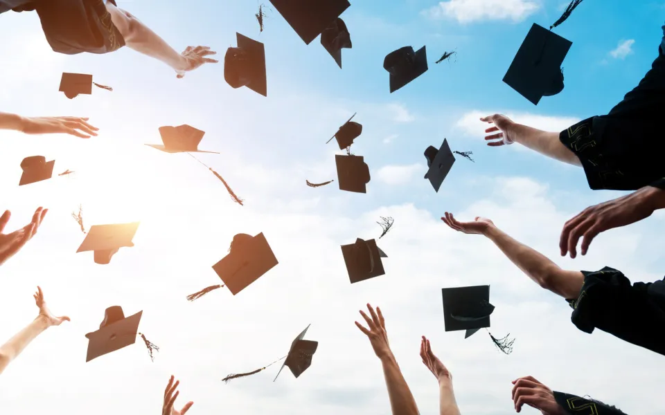Stock image of graduation caps